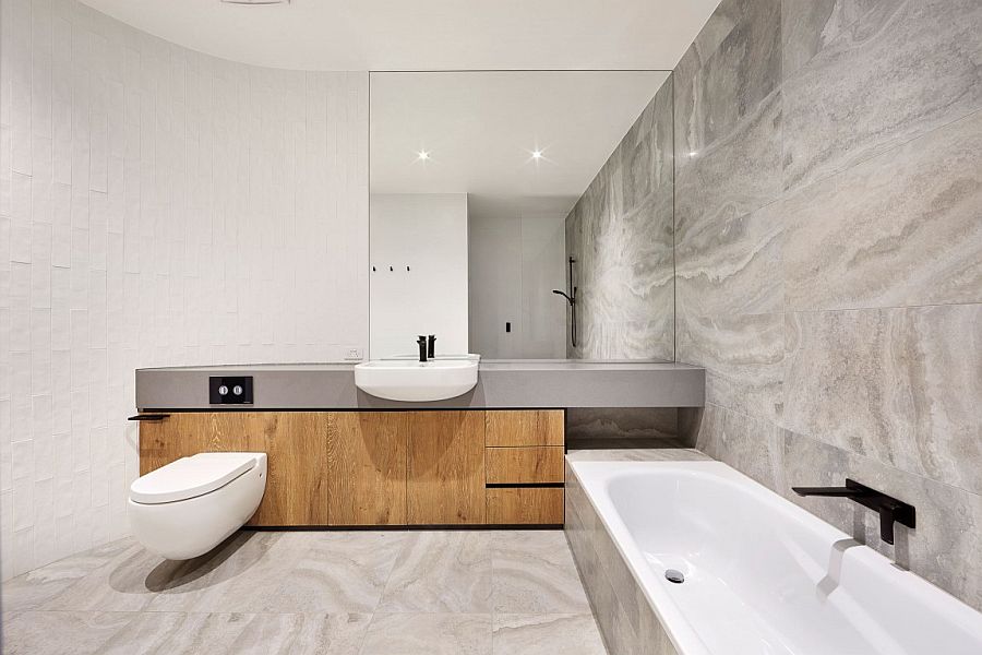 Minimal bathroom design in white and gray with curved wall