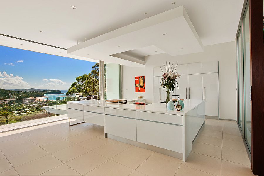 Minimal kitchen in white with a view of the distant coastline