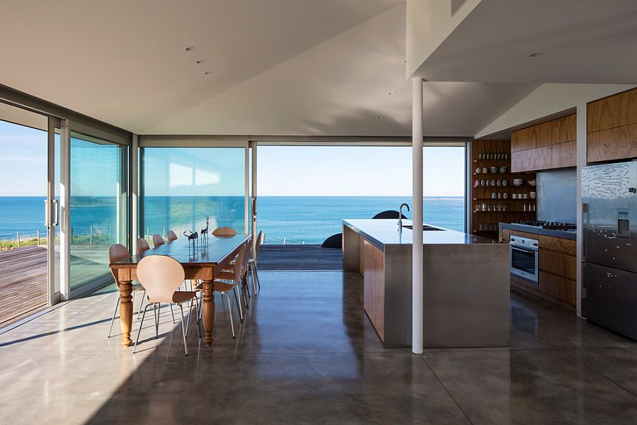 Modern kitchen overlooking the ocean as it flows into the timber deck outside