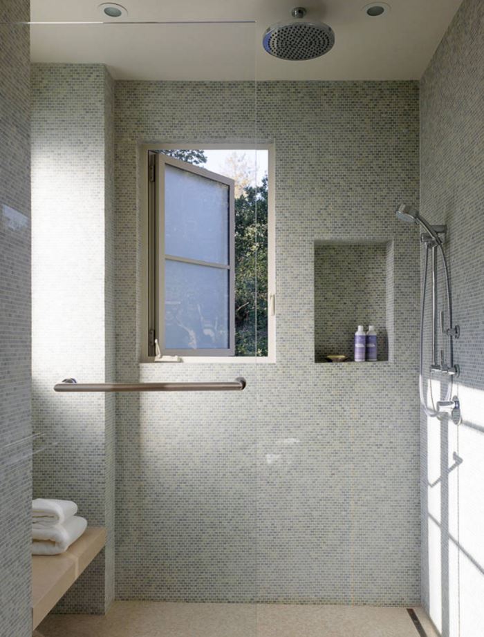 Multiple shower heads in a tiled bathroom