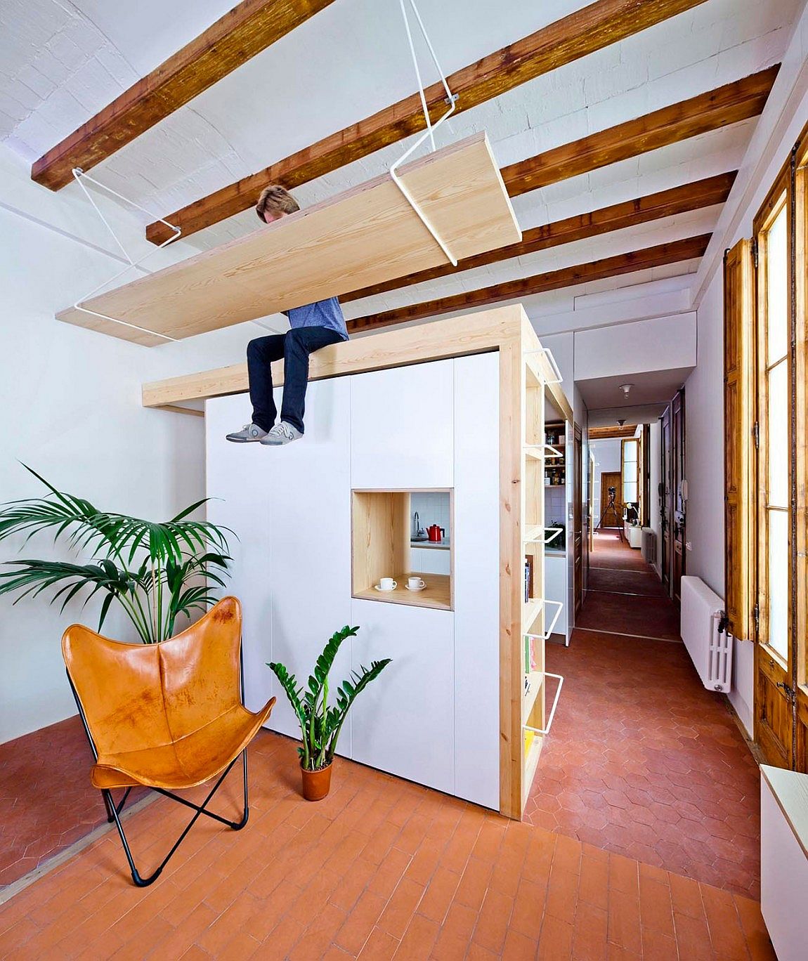 Open plan living area and kitchen of the Barcelona apartment makes use of vertical space