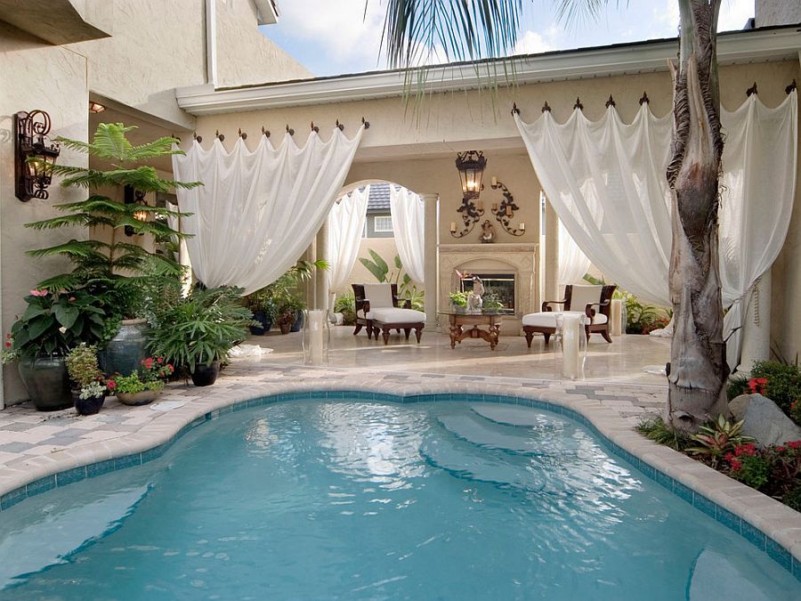 Outdoor drapery adds a hint of visual softness to the pool and its surrounding space