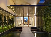Perfect-use-of-greenery-koi-pond-and-in-ground-lighting-to-fashion-a-captivating-entrance-217x155