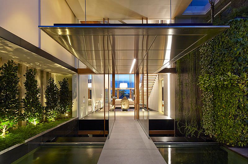 Perfect use of greenery, koi pond and in-ground lighting to fashion a captivating entrance