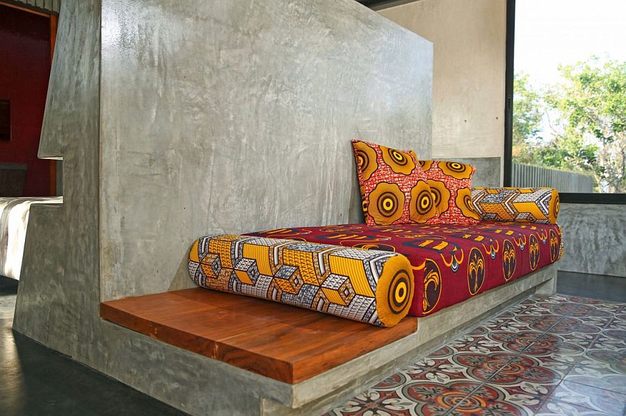 Polished cement seat and daybed with vivacious cushions