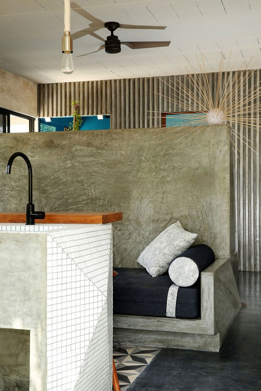 Polsihed cement bench in the kitchen with comfy cusion in dark blue