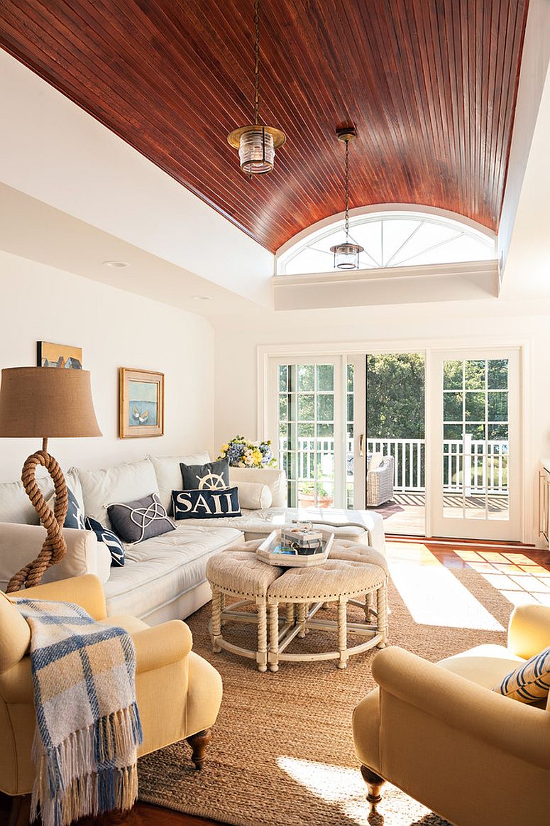 Rope lamp and throw pillows bring the coastal charm to this sunroom [Design: Gable Building Corp]