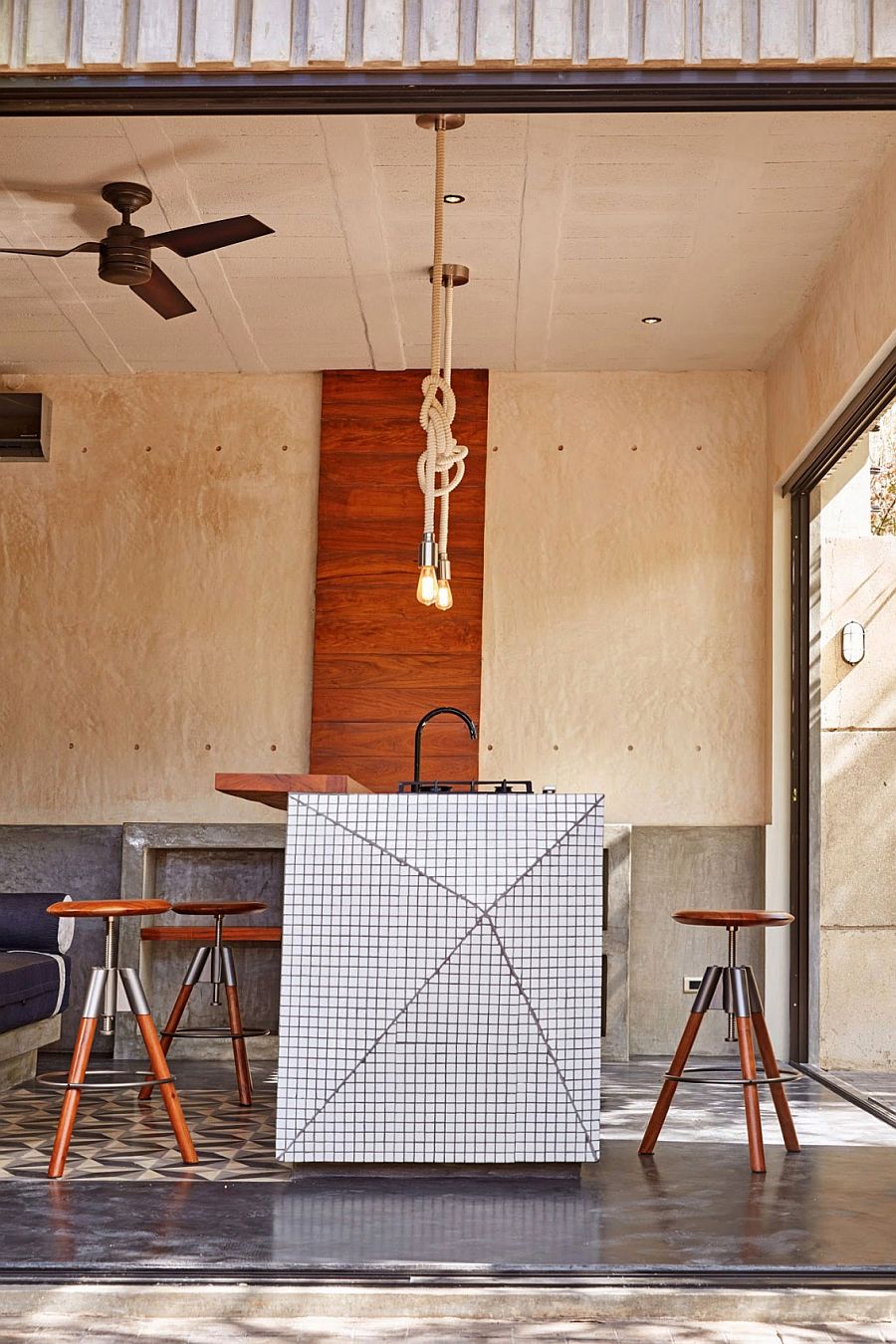 Rope pendants and fun stools give the kitchen a quirky look