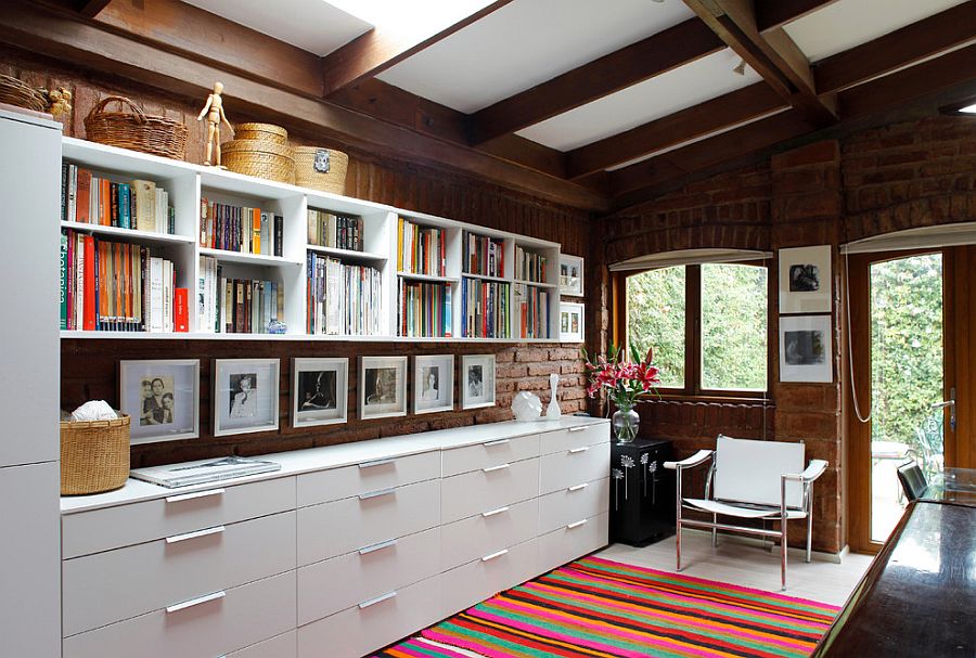 Series of open shelves and closed cabinets create ample storage space in this home office