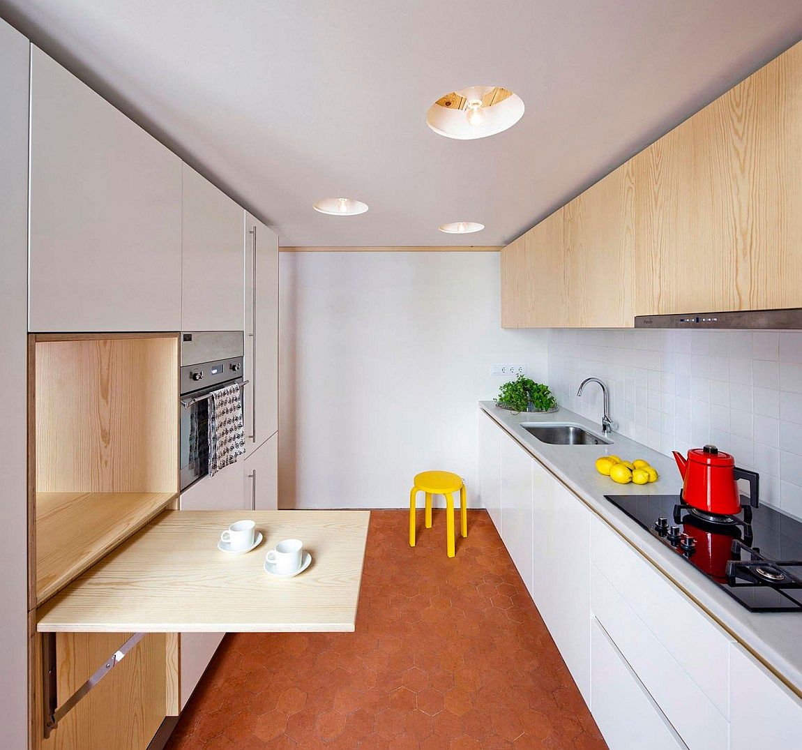 Smart kitchen deisgn for a small apartment acts as a distinct, standalone cabin space