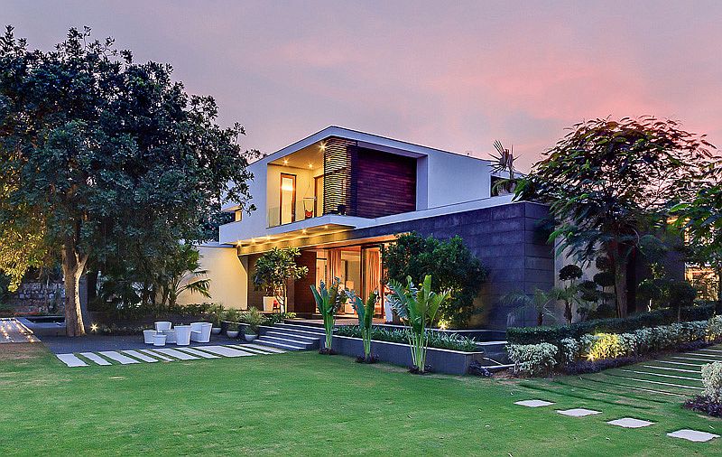 Stunning landscaped entry and reflective pond of contemporary farmhouse in Delhi