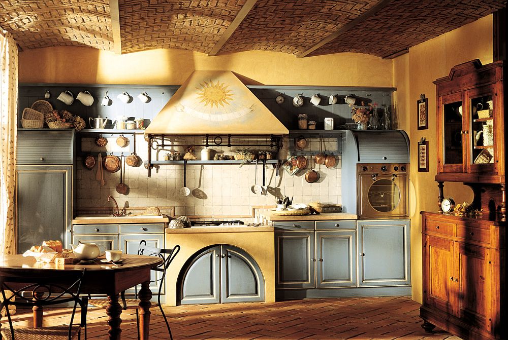 Sunburst motif on the hood drives home the Provencal Country style of the kitchen