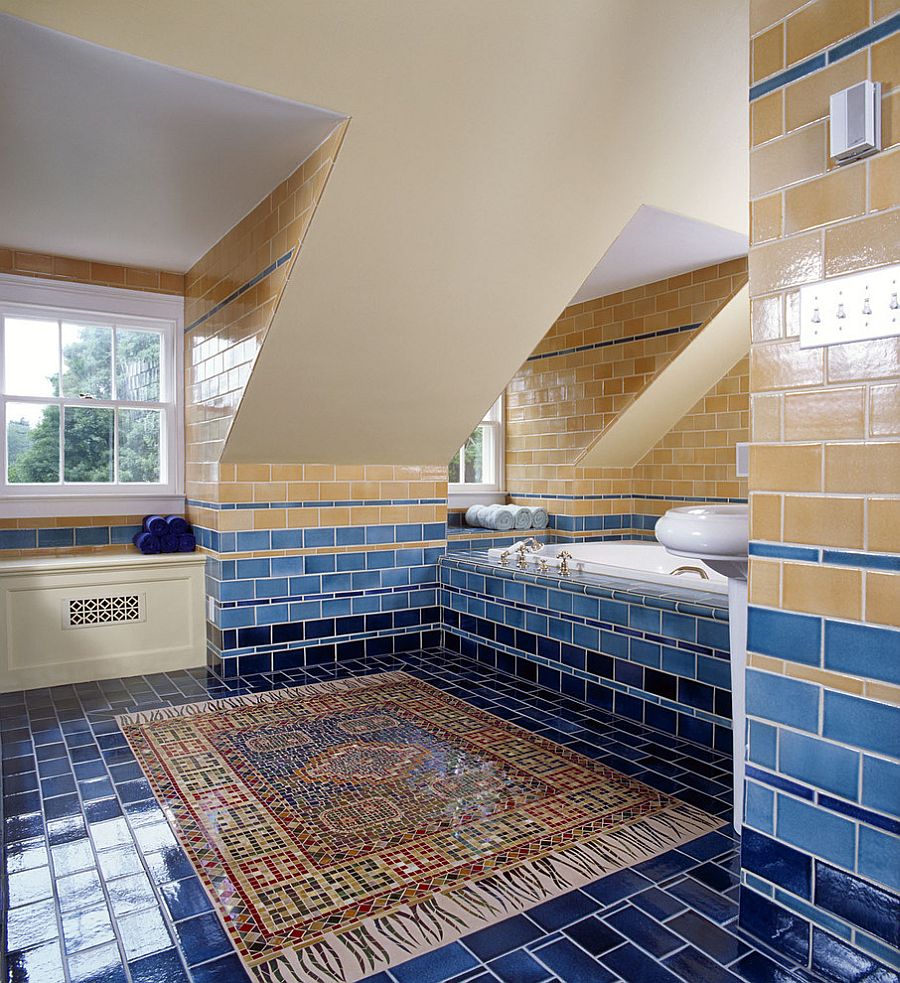 Tiled walls bring in various shades of yellow and blue into the bathroom [Design: Felhandler/ Steeneken Architects / Photography: Gridley & Graves]