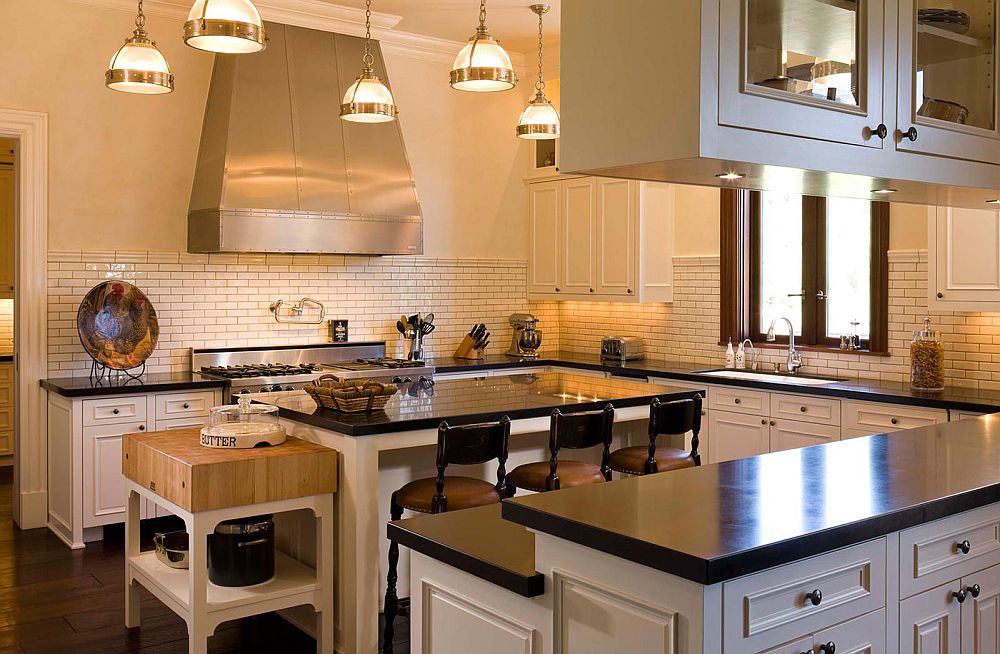 Traditional kitchen in white with a small butcher block station next to the central island