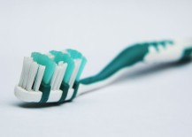 Use-an-old-toothbrush-to-scrub-away-debris-217x155