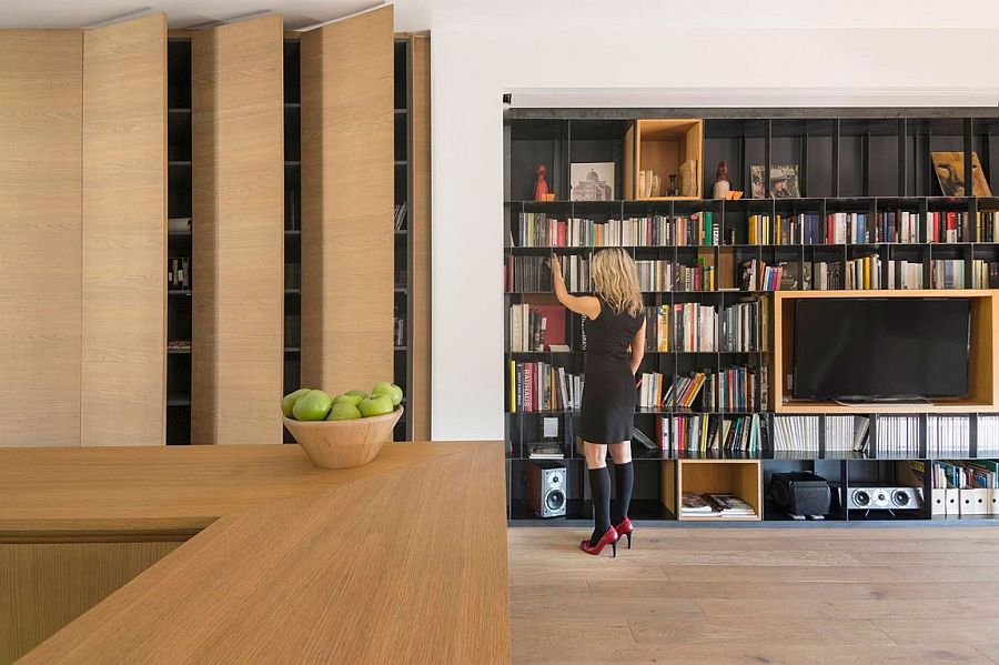 Use of custom wooden boxes adds contrast to the bookshelf in the living room