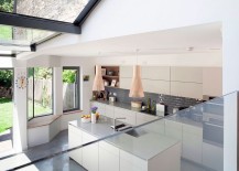 White-and-gray-kitchen-with-large-windows-Nelson-clock-and-Seppo-Koho-lighting-217x155