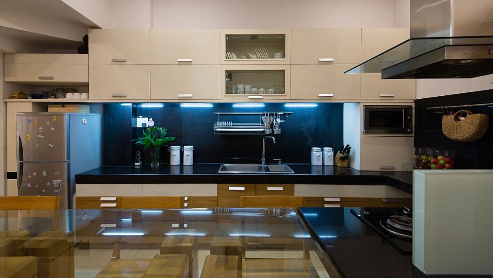 White cabinets and a dark backsplash fashion a cool, modern kitchen