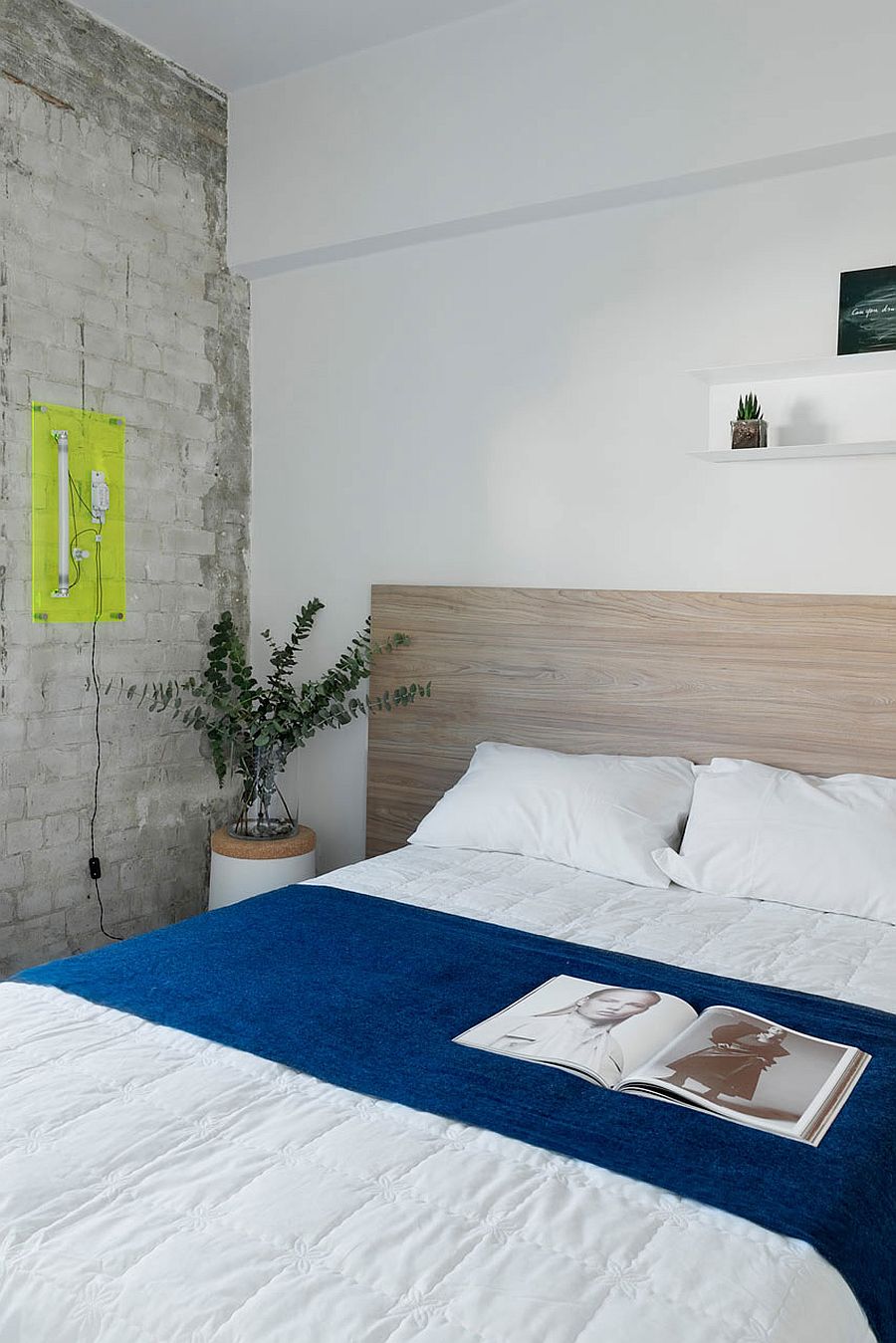 Whitewashed brick wall inside small, contemporary bedroom