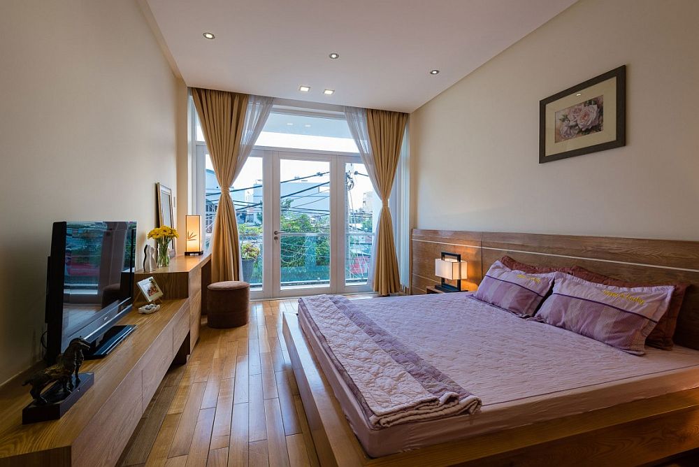 Wooden bed and headboard in the modern bedroom feel like an extension of the floor