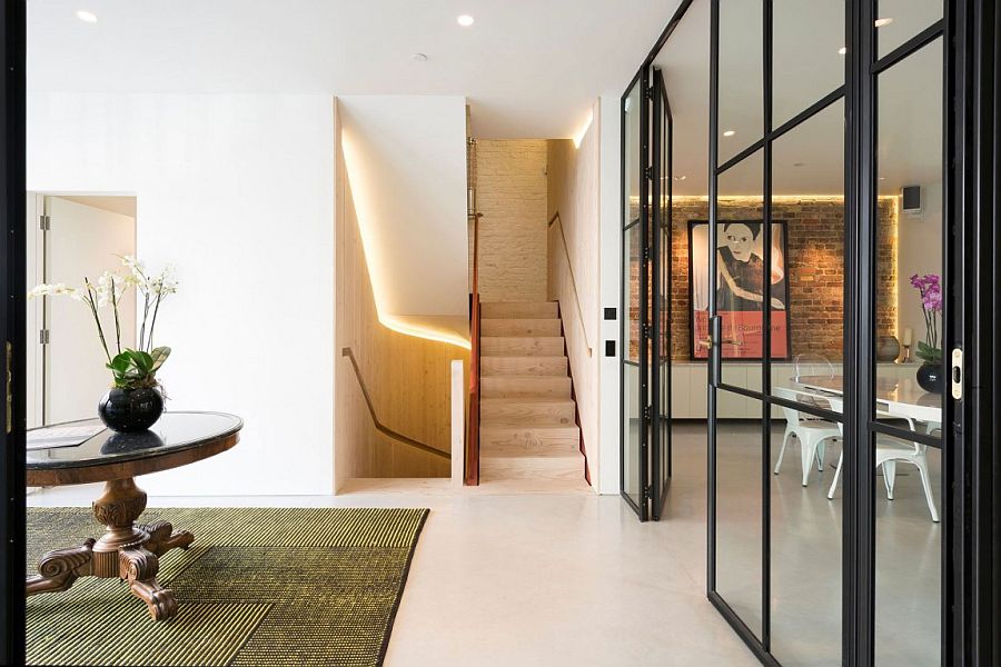 Wooden staircase connects the variors levels of the revamped London home
