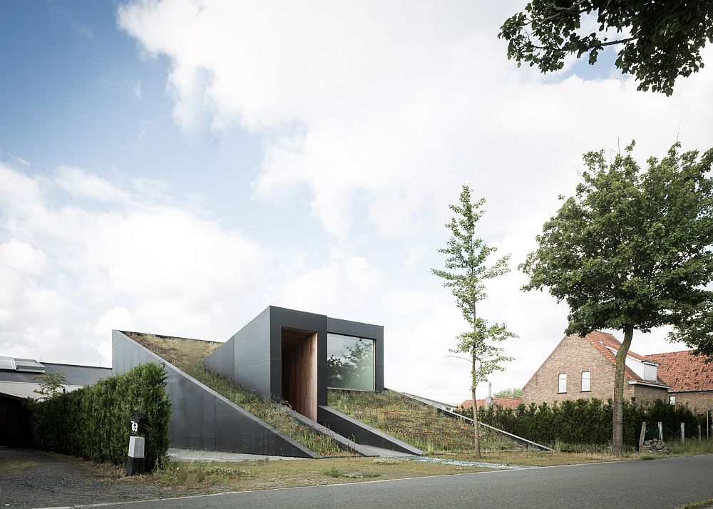 A view of the underground split-level house with a green roof