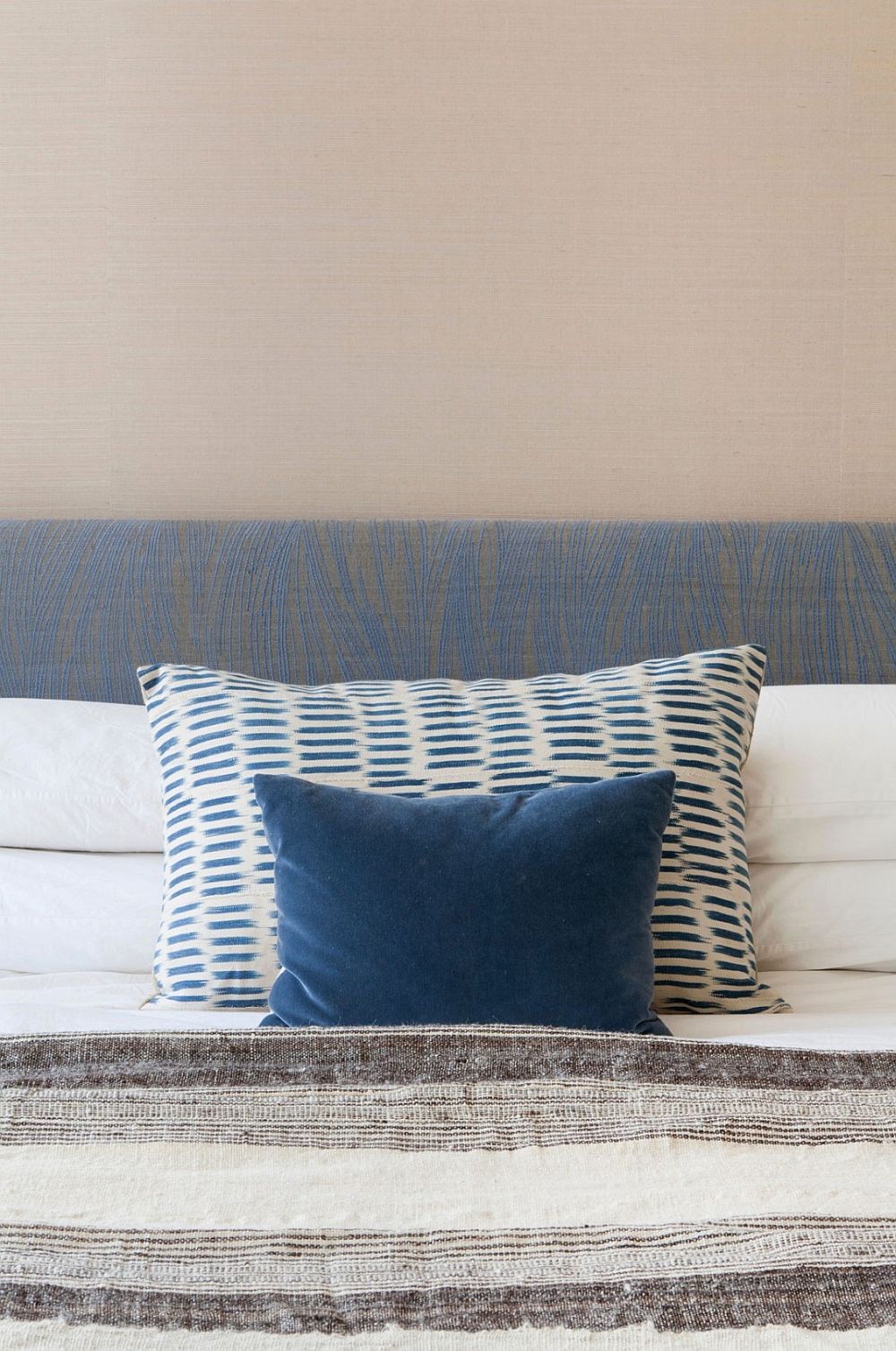 Bedroom with grasscloth walls and blue accents