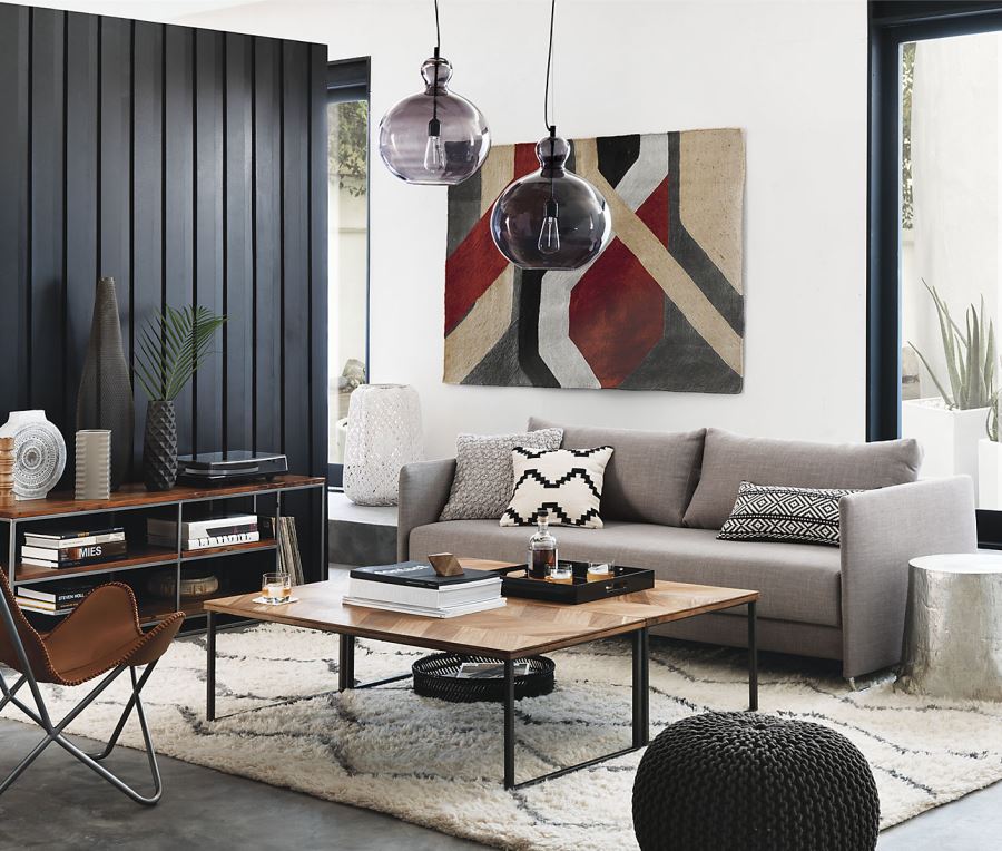 Black vertical wall paneling in a room designed by CB2