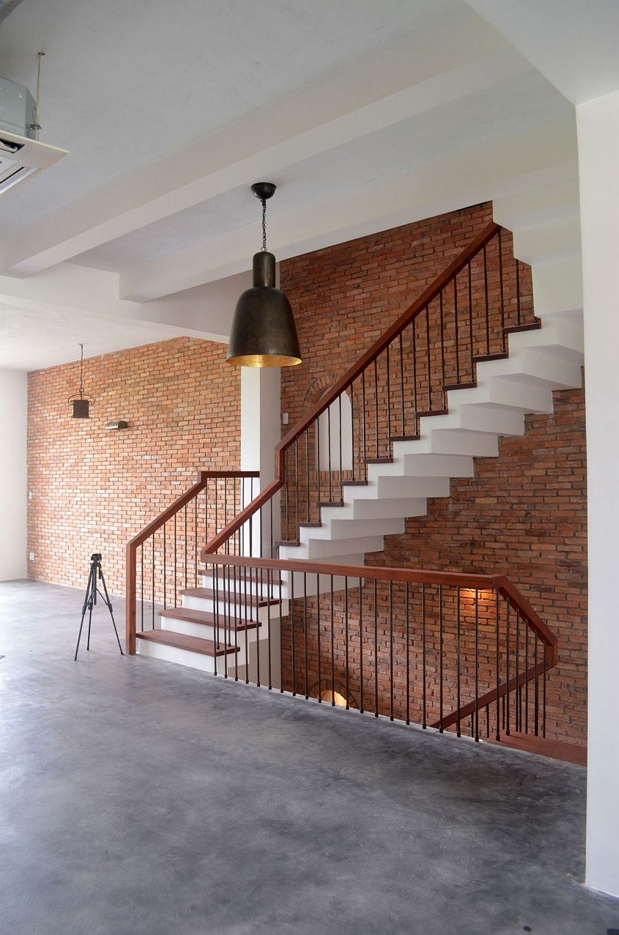 Brick draped staircase wall adds character to the interior