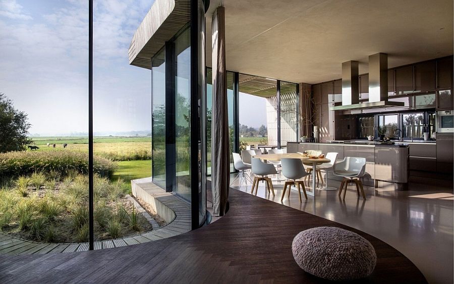Curved seat along with the kitchen and dining area inside the sustainable dutch home