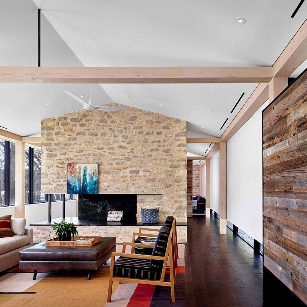 Gorgeous living room of Prefab Austin Home with stone accent wall and wooden walls