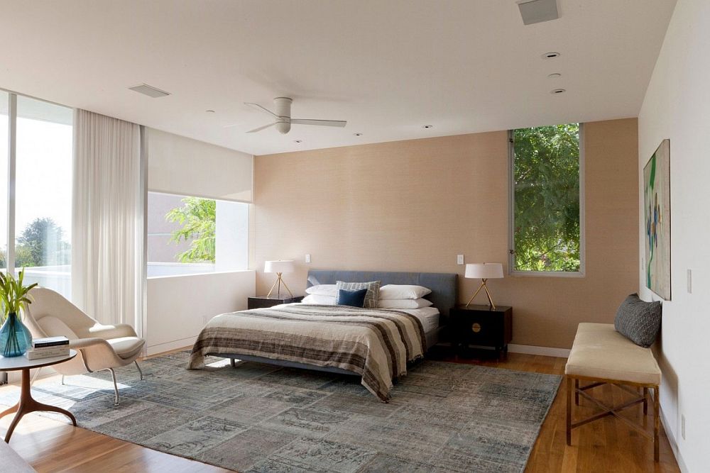 Grasscloth wallpaper brings an earthen vibe to the bedroom