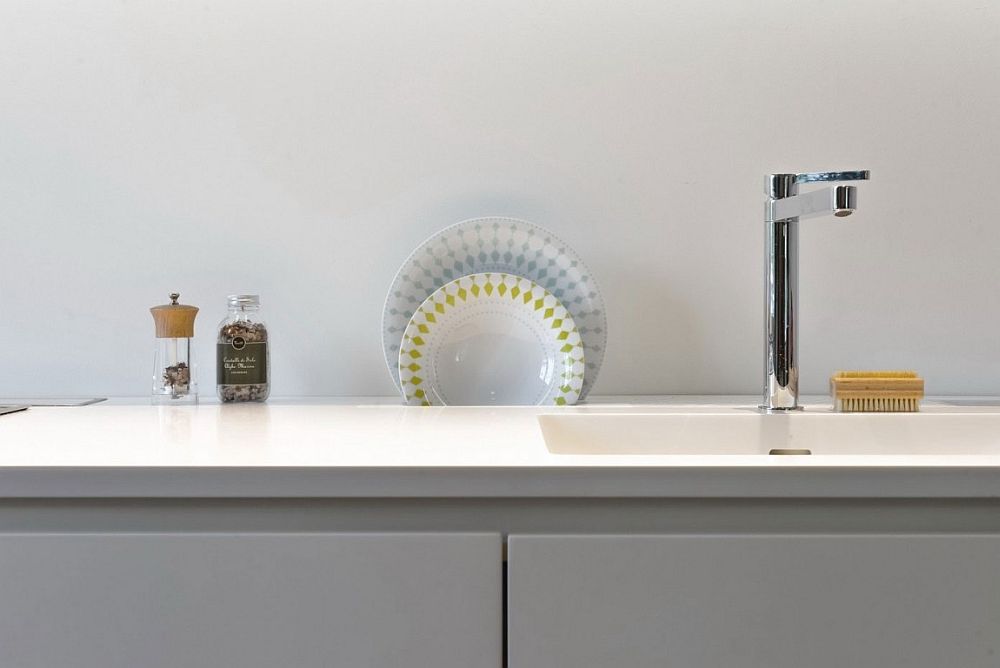 Gray and white shape the contemporary kitchen inside the Milan home