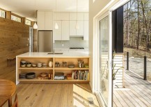 Kitchen-at-the-lovely-family-cottage-connected-to-the-outdoors-through-glass-doors-and-wooden-deck-217x155