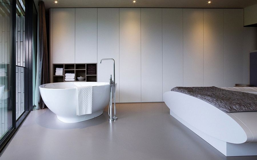 Minimal master bedroom in white with bathtub