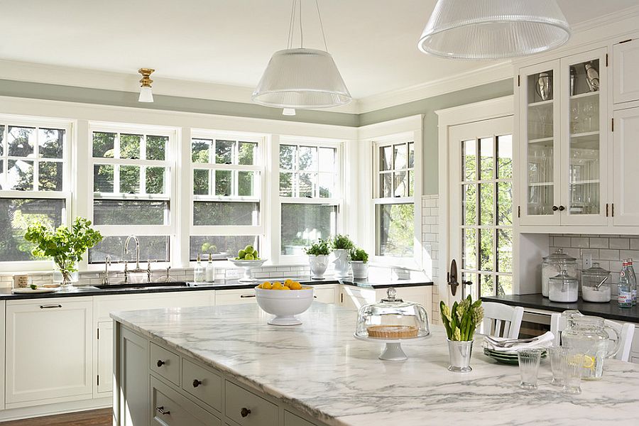 Modern pendants fit in seamlessly with the traditional backdrop of the kitchen [Design: Welch Forsman Associates]