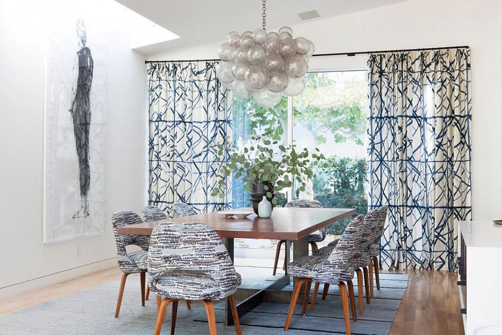 Pattern of the drapes adds to the dining table chairs and complements them beautifully