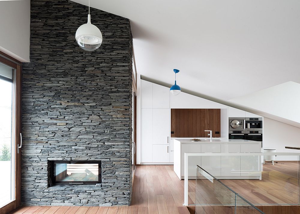 Stone wall with fireplace and kitchen of the beautiful Belgian house