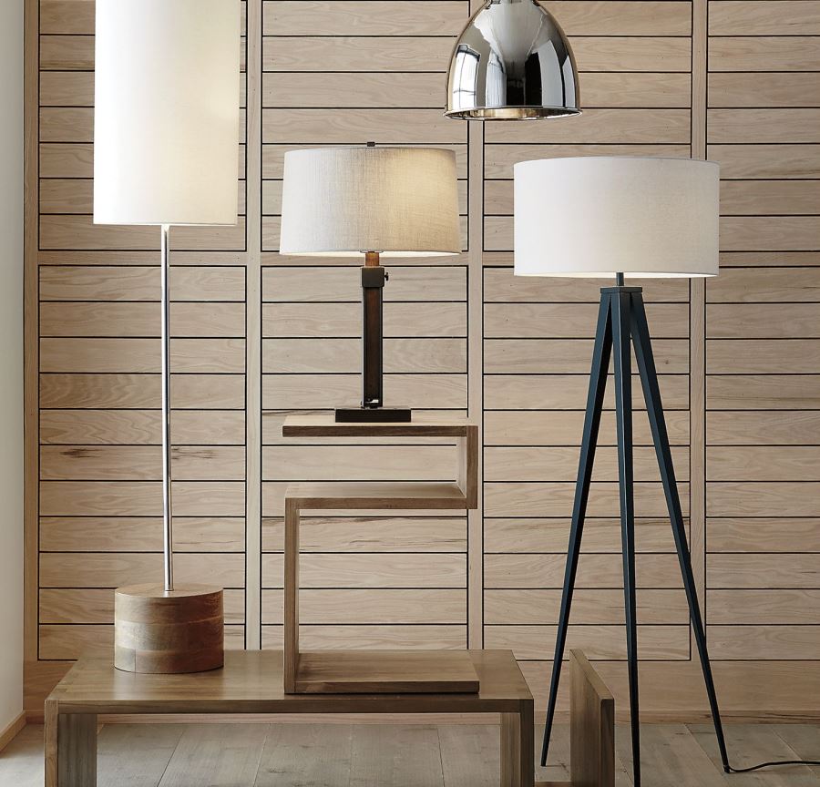 Wood paneling behind a collection of lamps