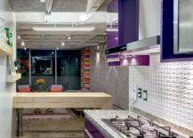 Aubergine-purple-polyester-cabinets-and-recycled-timber-breakfast-bench-inside-the-small-kitchen-217x155