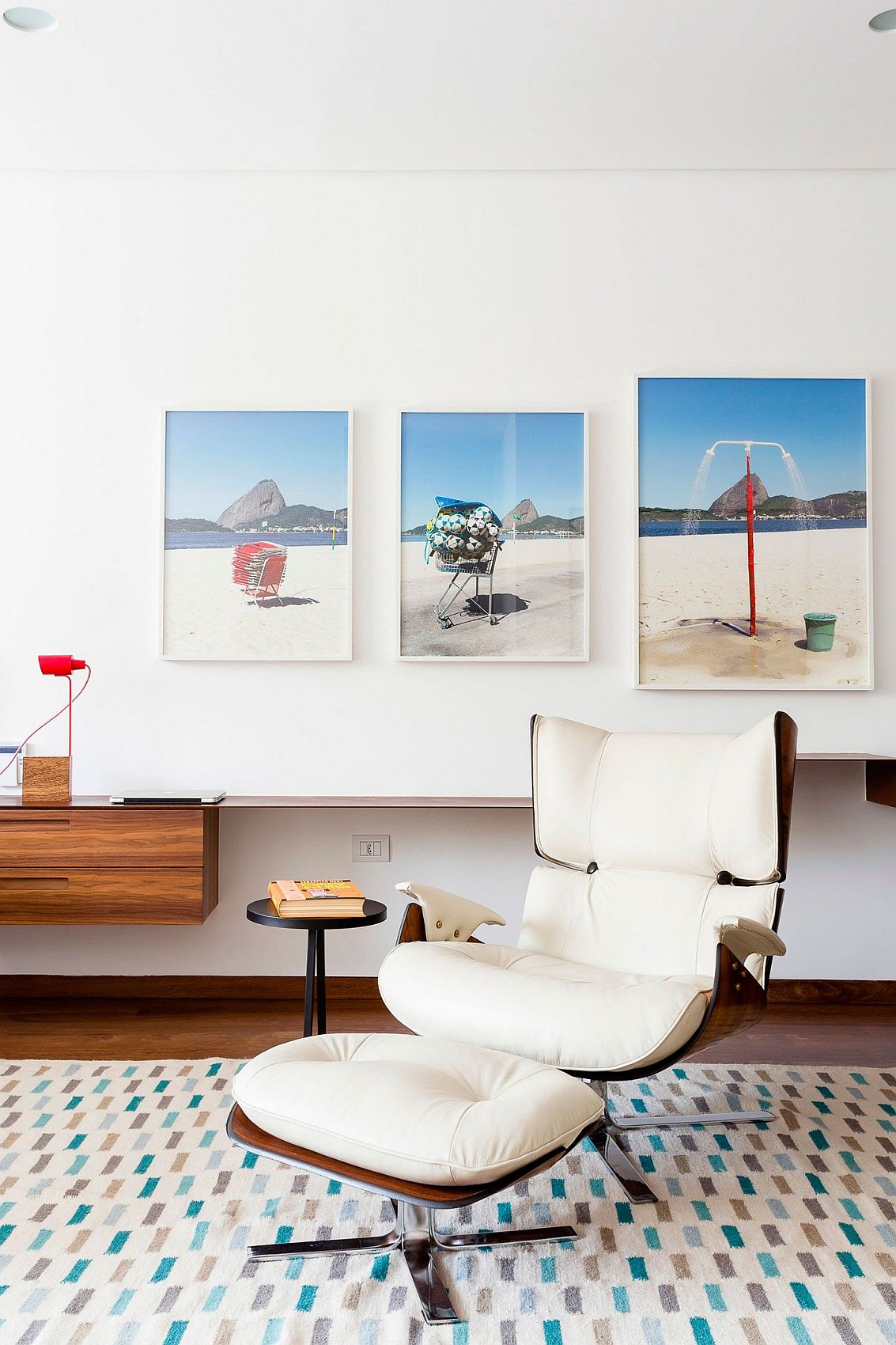 Beach-themed photographs set the mood in the bedroom of the Brazilian home