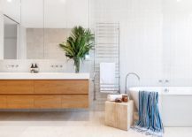 Contemporary-bathroom-in-white-with-wooden-floating-vanity-and-a-small-stool-next-to-the-bathtub-217x155