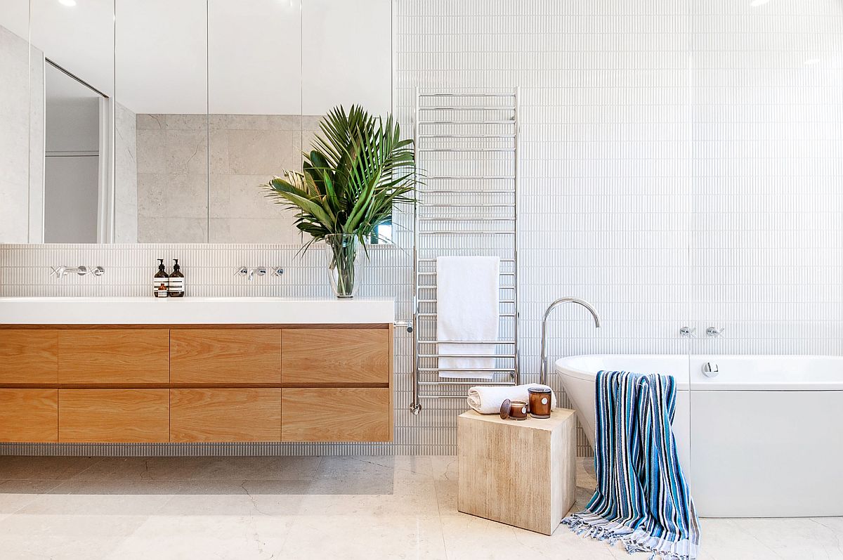 Contemporary bathroom in white with wooden floating vanity and a small stool next to the bathtub