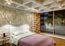 Contemporary-bedroom-with-custom-wooden-flooring-and-concrete-walls-217x155