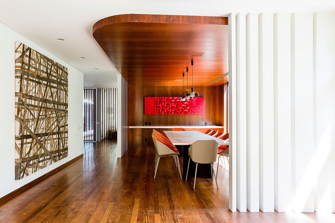 Curved false ceiling design demarcates the dining space in the open floor plan