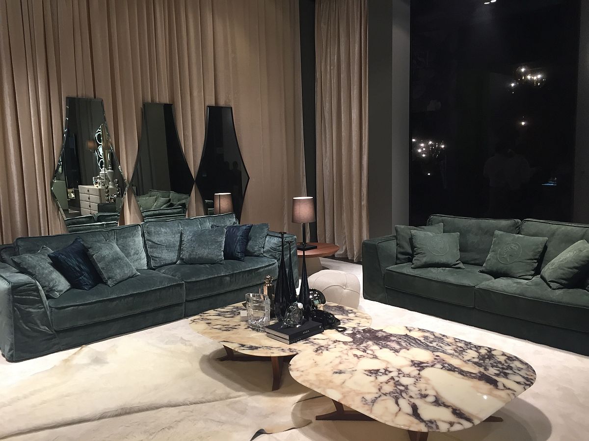Custom mirrors in the backdrop and coffee tables with marble top also add to the refined living room design - Alberta Salotti at Milan 2016