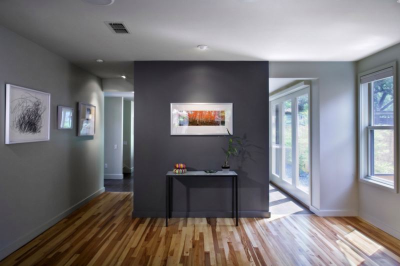 Dark grey accent wall in a grey room