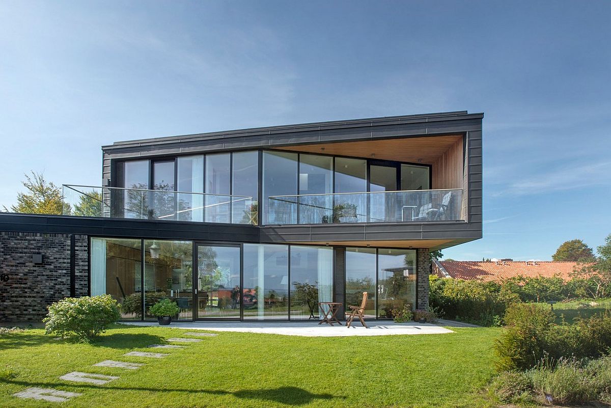 Dark patinated zinc and glass shape the facade of the spacious home in Denmark