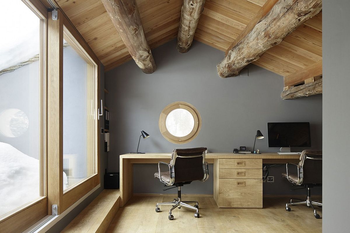 Exposed timber beams give the attic home office a great and unique ambiance