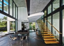 Exquisite-living-area-with-glass-walls-and-floating-staircase-217x155